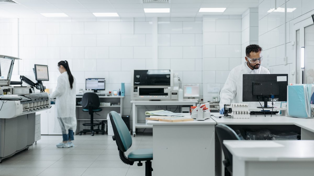Healthcare lab technicians working in a clinical data facility