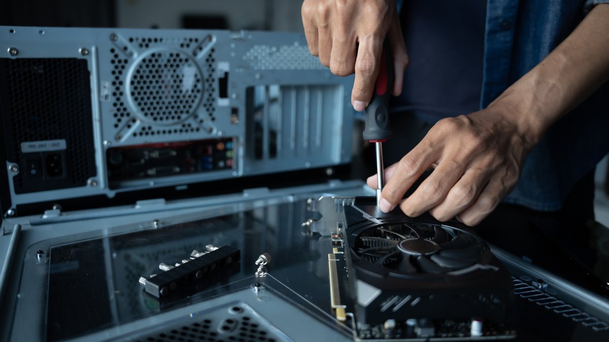 Technician installing hardware component in an IT asset